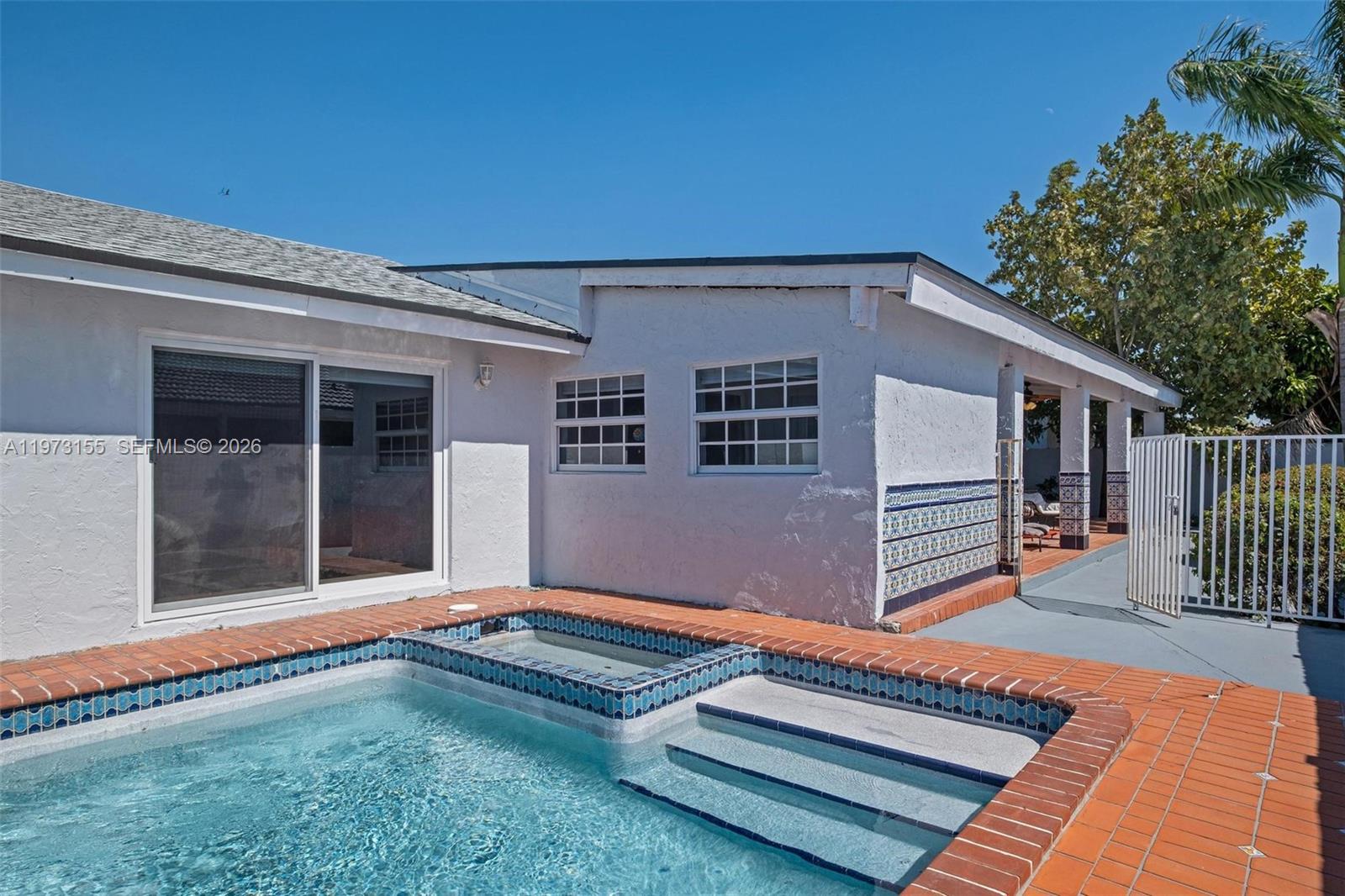13710 Southwest 18th Terrace Miami, FL 33175 - Photo 37 of 46 a backyard of a house with deck and outdoor seating
