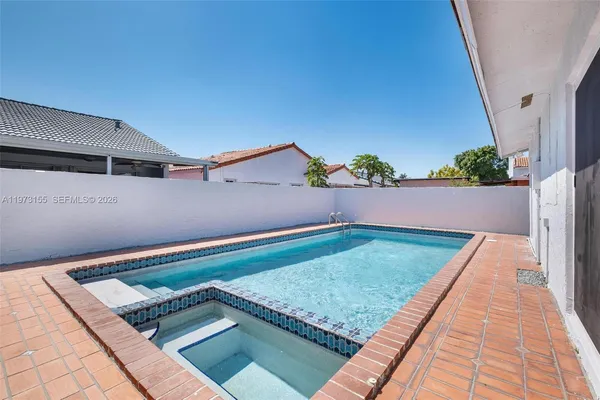 an aerial view of a house with swimming pool and outdoor space