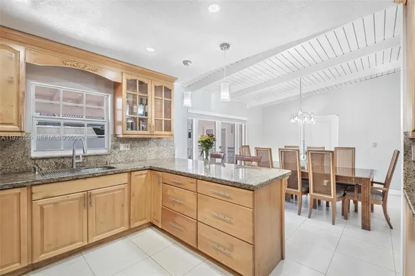 a kitchen with sink and cabinets