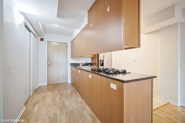 a kitchen with stainless steel appliances granite countertop a stove a refrigerator and a microwave