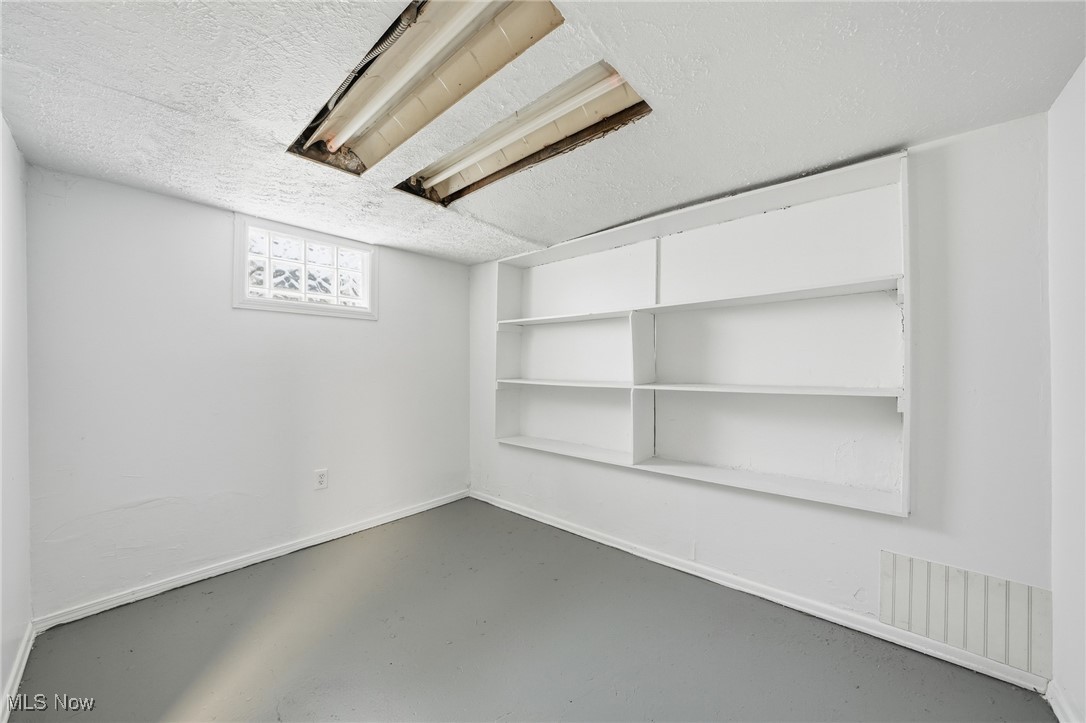 7911 Snow Road Parma, OH 44129 - Photo 36 of 44 Below grade area featuring a textured ceiling