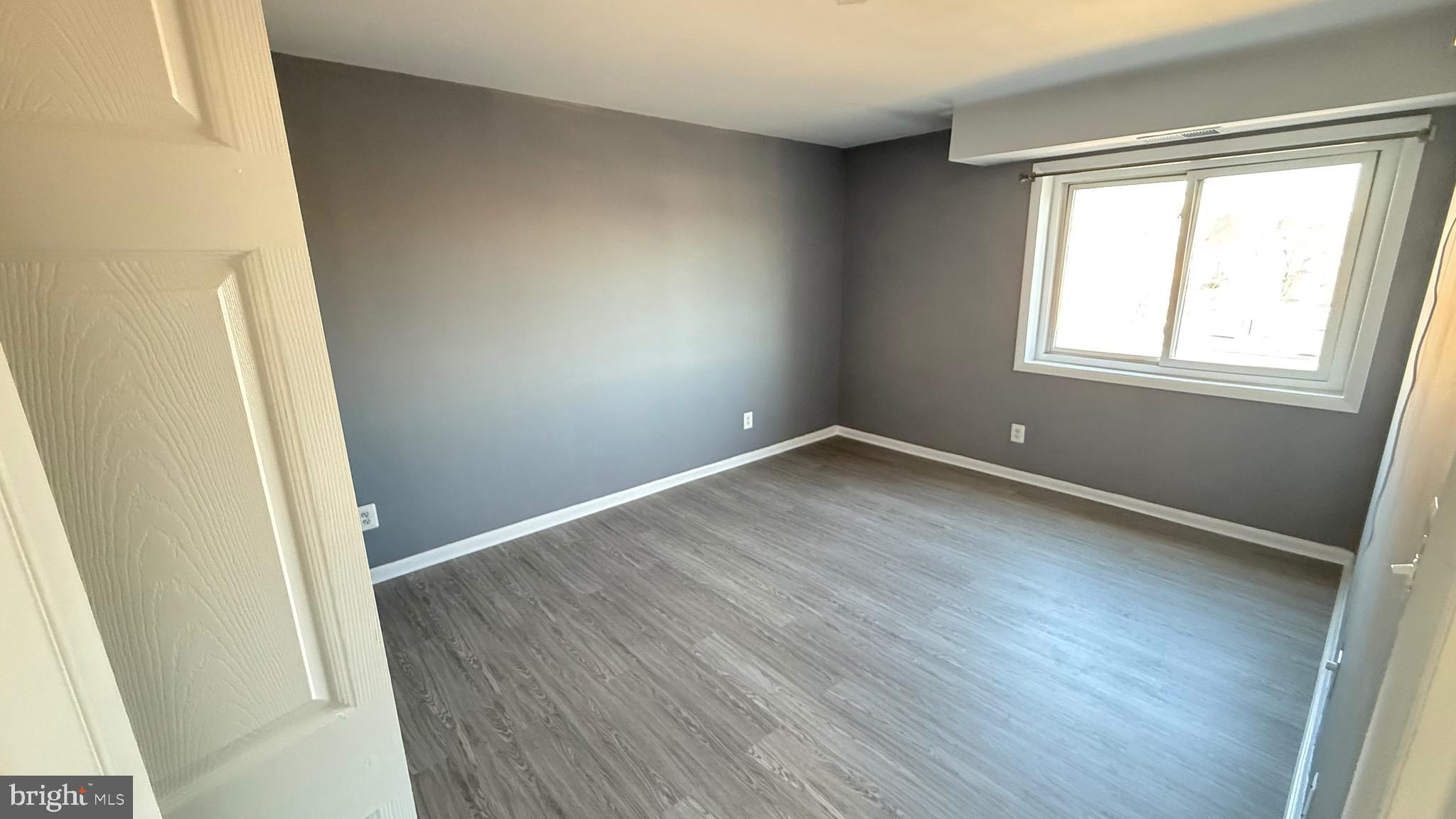 3400 25th Street South, Unit 27 Arlington, VA 22206 - Photo 16 of 23 an empty room with wooden floor and windows