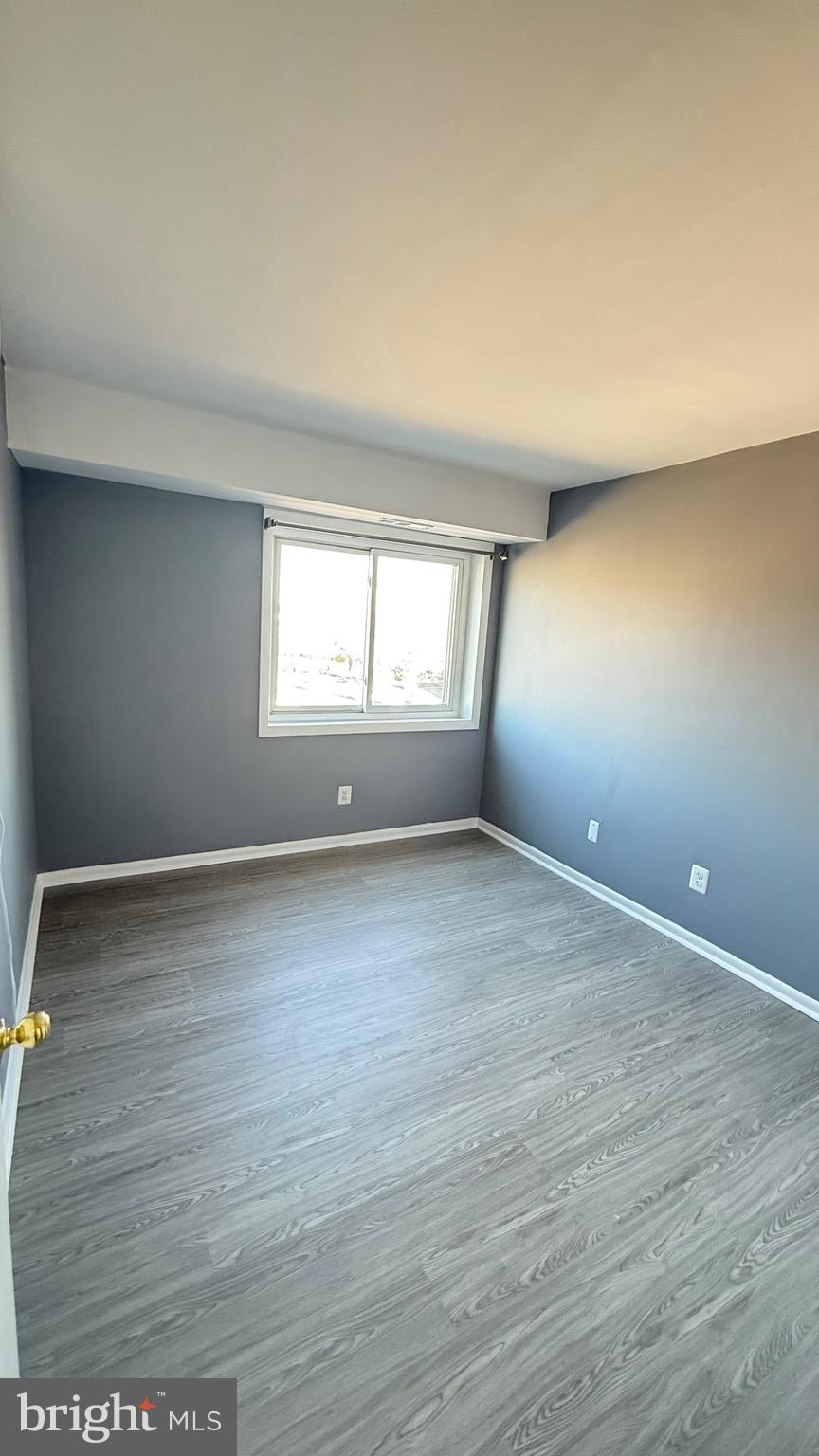 3400 25th Street South, Unit 27 Arlington, VA 22206 - Photo 18 of 23 an empty room with wooden floor and windows