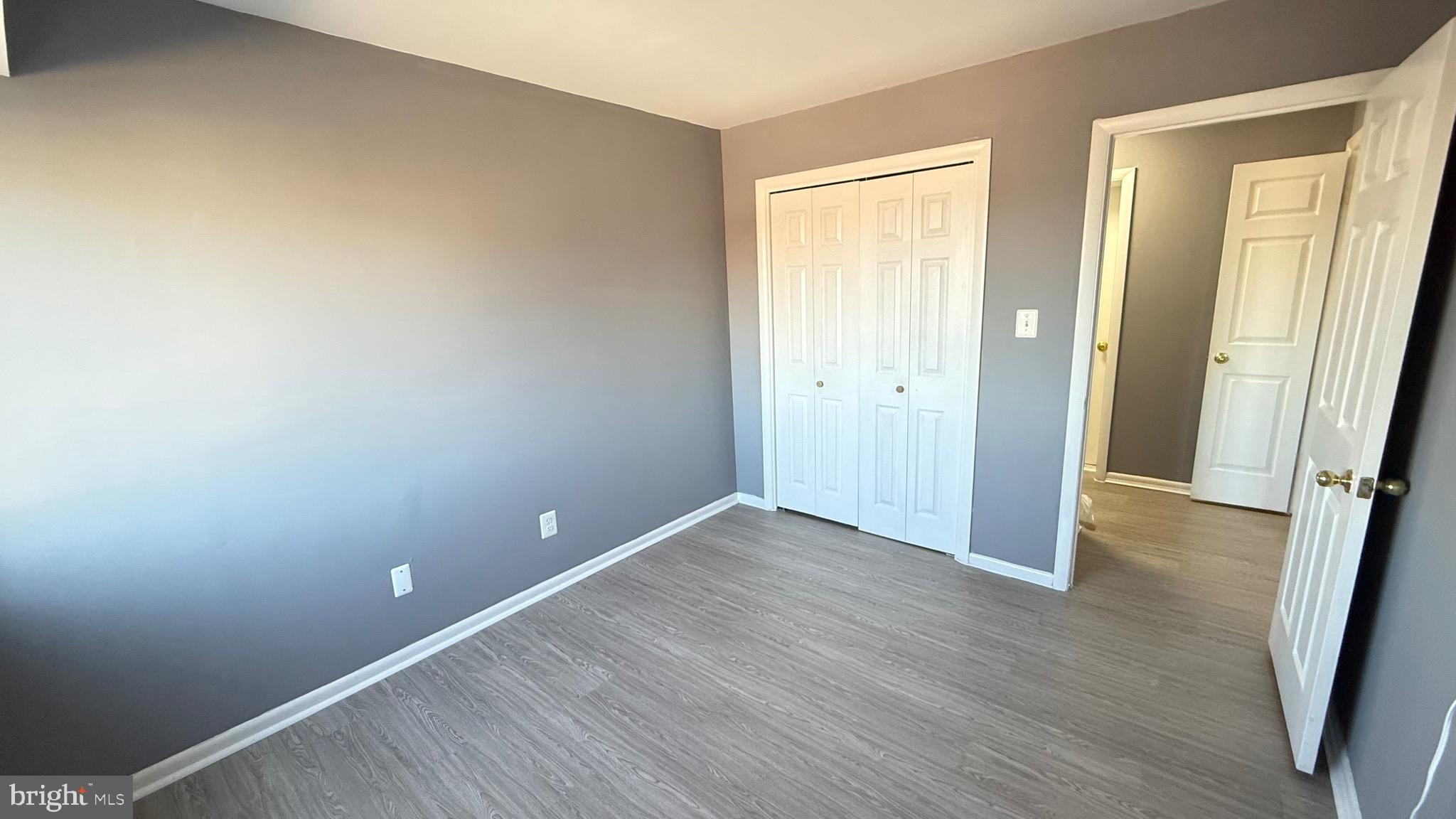 3400 25th Street South, Unit 27 Arlington, VA 22206 - Photo 19 of 23 a view of an empty room with wooden floor and a window