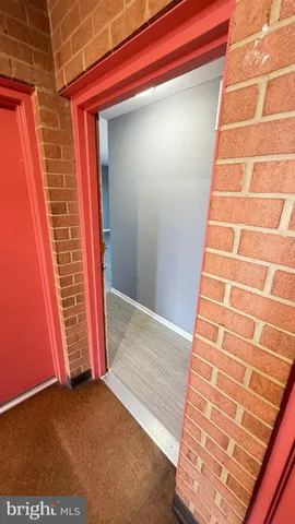 a view of a room with wooden floor and a ceiling fan
