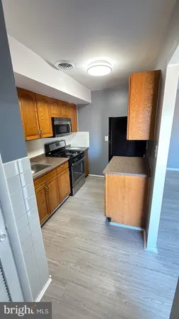 a kitchen with a sink a stove and cabinets
