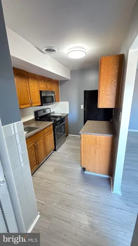 a kitchen with a sink a stove and cabinets