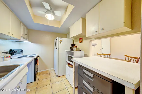 a utility room with cabinets washer and dryer