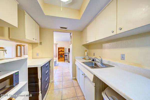 a kitchen with a sink a stove and cabinets