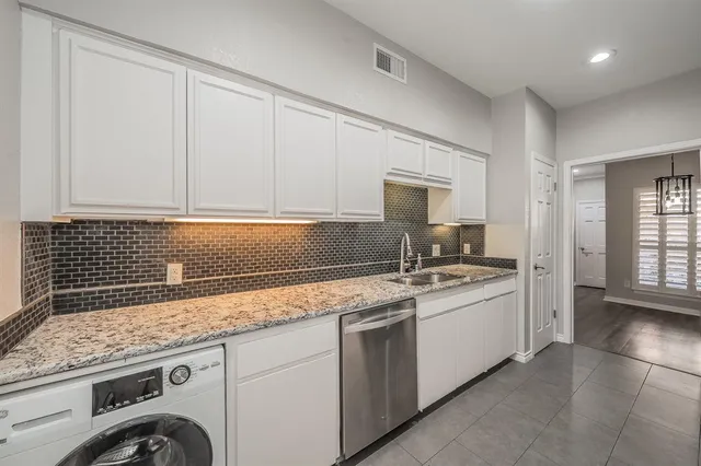 a kitchen with stainless steel appliances granite countertop a sink and a stove