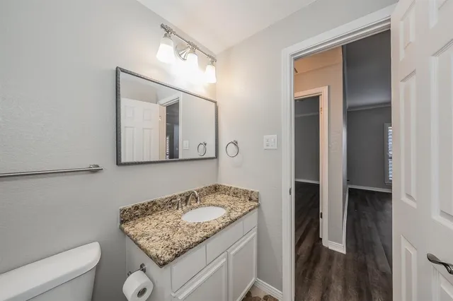 a bathroom with a granite countertop sink and a mirror