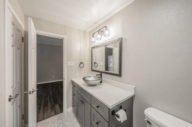 a bathroom with a sink a toilet and mirror