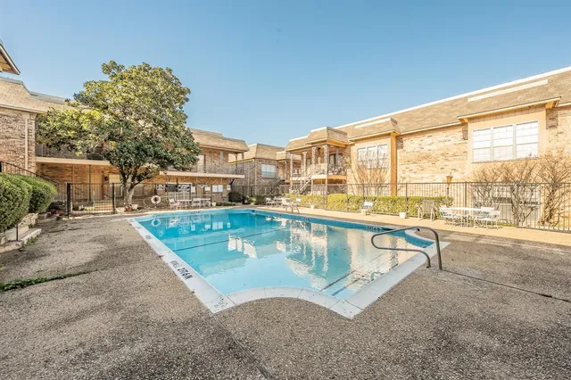 a view of a swimming pool with outdoor seating