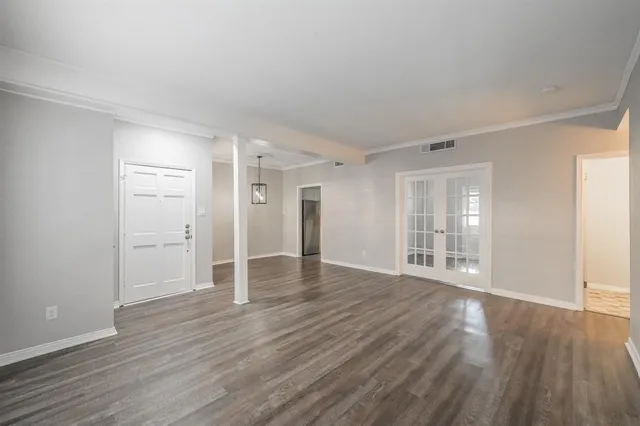a view of wooden floor and windows in a room