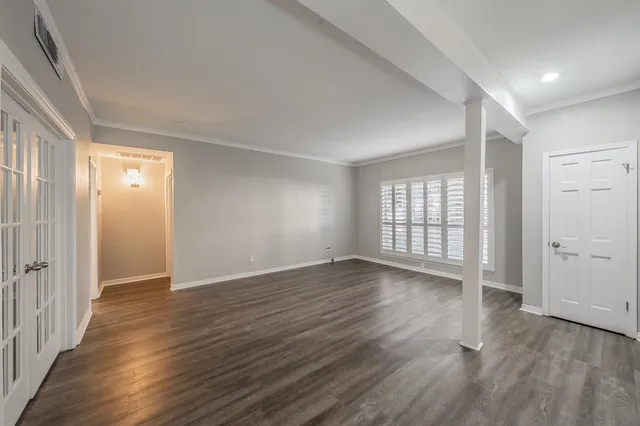 wooden floor in an empty room with a window