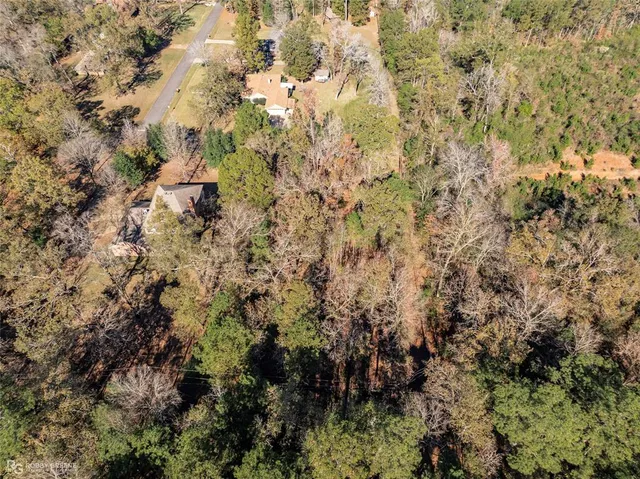 a view of a wooden house and a yard