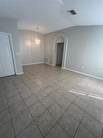 a view of a livingroom with wooden floor and a window
