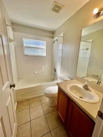 a large bathroom with a double vanity sink a mirror and a bathtub