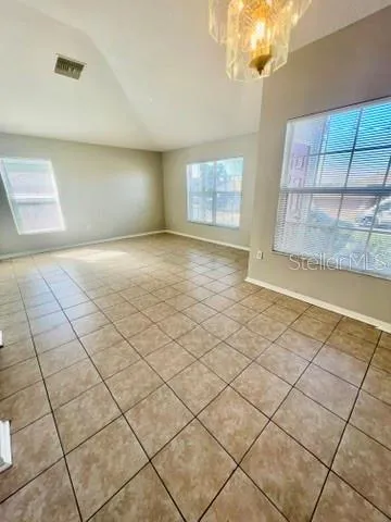 a view of an empty room and a window