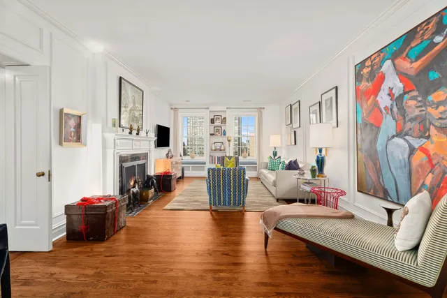 a living room with fireplace furniture and a wooden floor