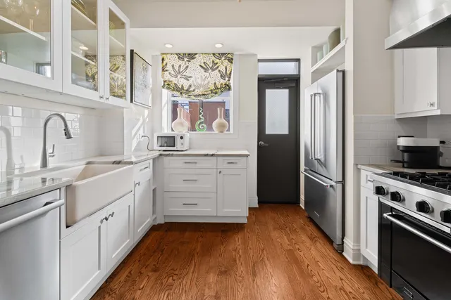 a kitchen with stainless steel appliances a stove sink and refrigerator