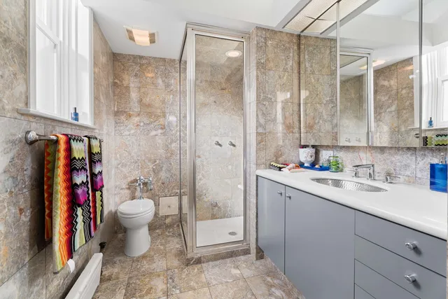 a bathroom with a sink toilet and shower