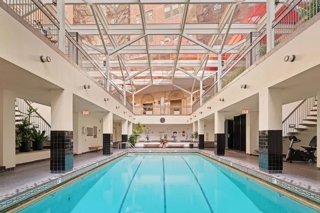 a view of a living room with a large kitchen area and a large window