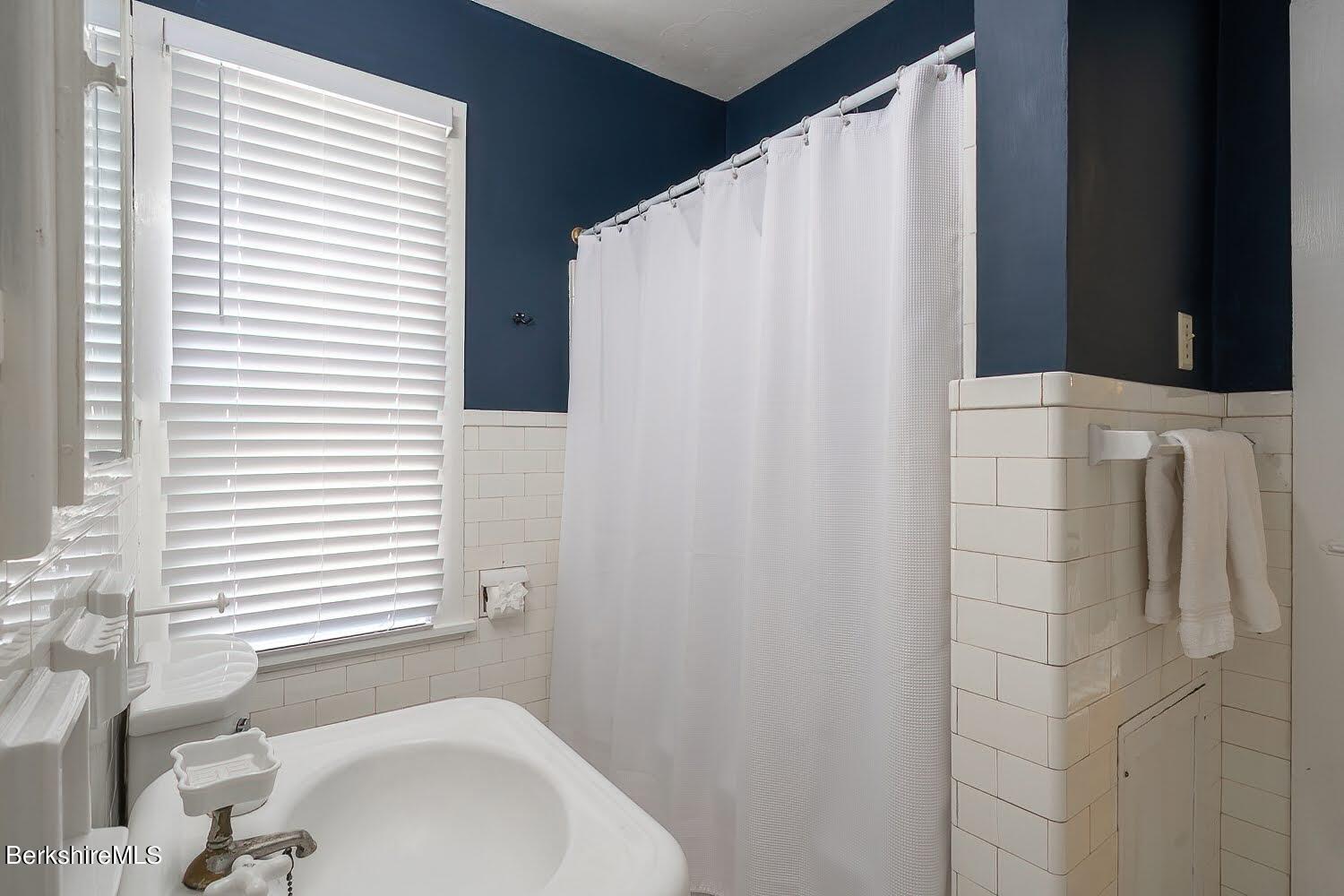 39 Main Street Stockbridge, MA 01262 - Photo 25 of 39 a bathroom with a sink and a shower curtain