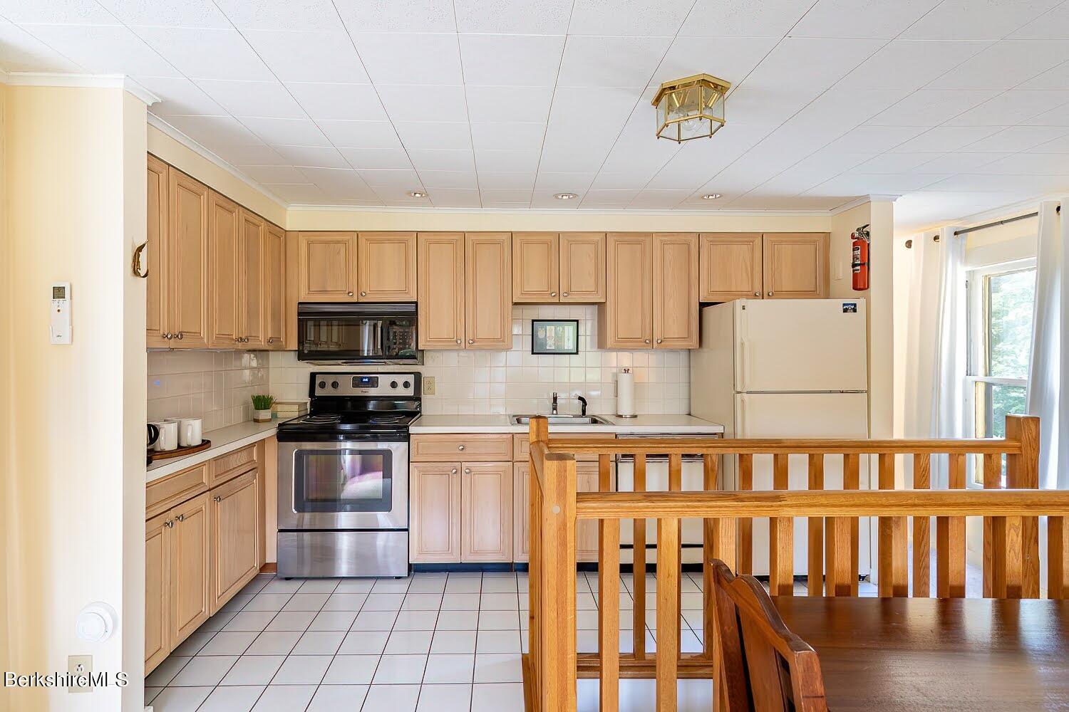 39 Main Street Stockbridge, MA 01262 - Photo 28 of 39 a kitchen with stainless steel appliances granite countertop a refrigerator and a stove top oven