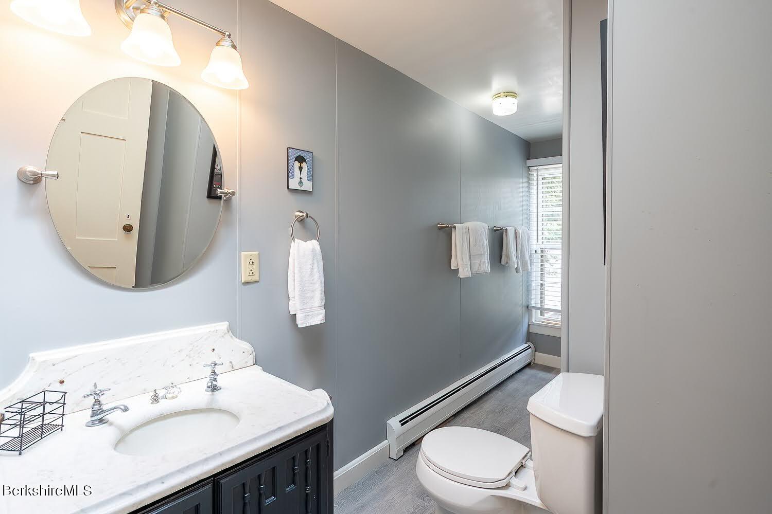 39 Main Street Stockbridge, MA 01262 - Photo 31 of 39 a white toilet sitting next to a bathroom sink