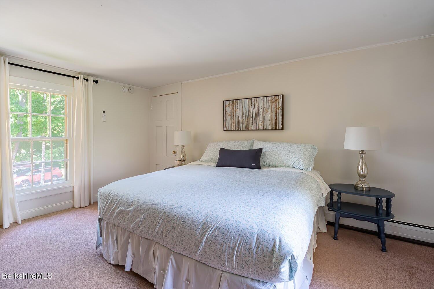 39 Main Street Stockbridge, MA 01262 - Photo 32 of 39 a bedroom with a bed and a lamp next to a window