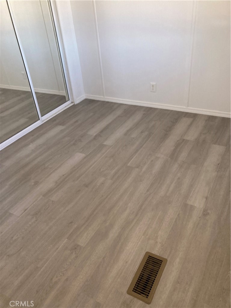 6376 Coyote Road Phelan, CA 92371 - Photo 11 of 19 an empty room with wooden floor