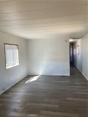 a kitchen with a white cabinets and window