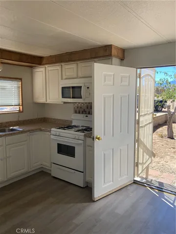 a kitchen with a refrigerator and a sink