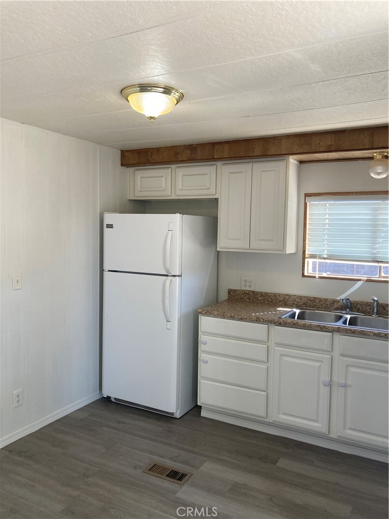 6376 Coyote Road Phelan, CA 92371 - Photo 5 of 19 a kitchen with a refrigerator and a sink