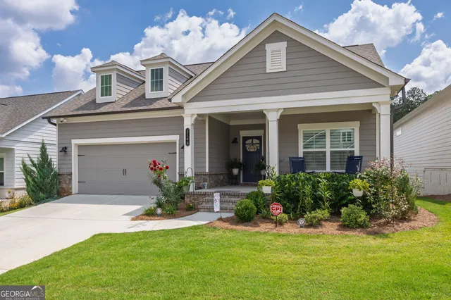 a front view of a house with a yard and garage