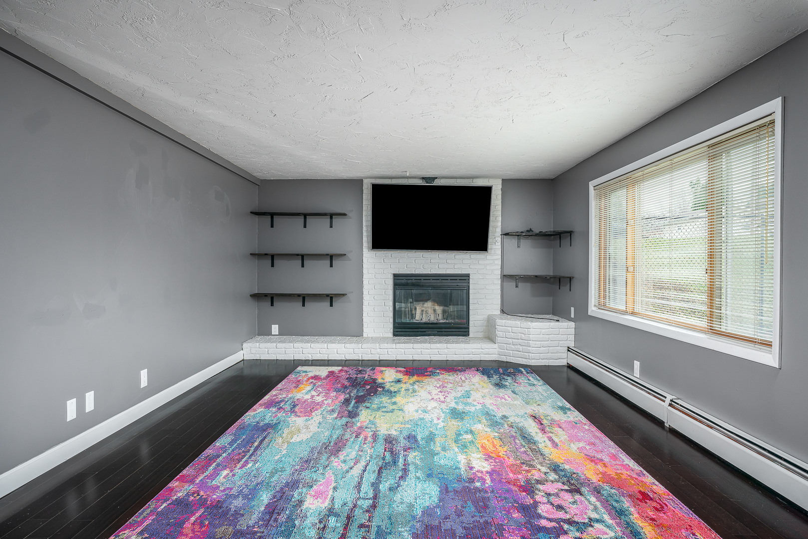 5302 32nd Avenue Moline, IL 61265 - Photo 21 of 30 a living room with a fireplace and a flat screen tv
