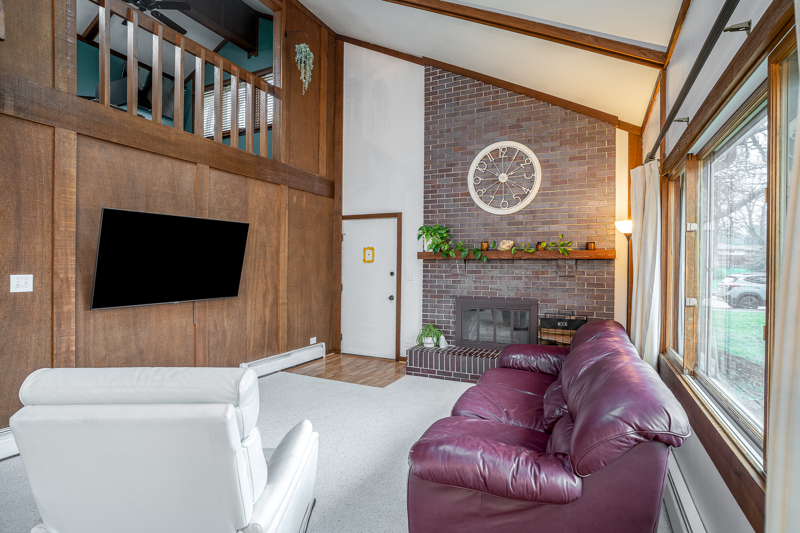 5302 32nd Avenue Moline, IL 61265 - Photo 8 of 30 a living room with furniture a flat screen tv and a fireplace