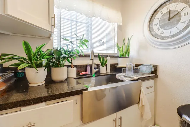 a view of a patio with table and chairs under an umbrella