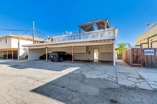 a aerial view of a house with a yard and potted plants