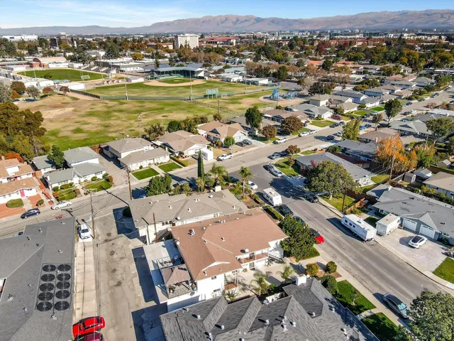an aerial view of residential houses with outdoor space