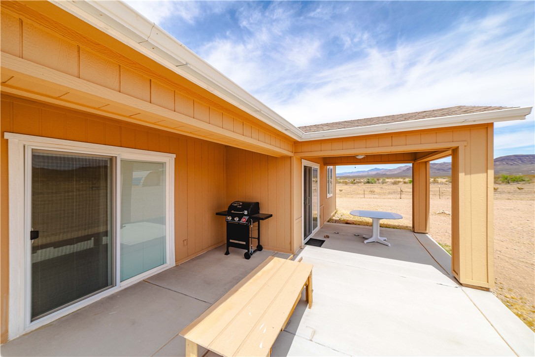 2948 Pinal Road Golden Valley, AZ 86413 - Photo 37 of 59 Expansive concrete patio offering a covered area with recessed lighting, an open-air section, and direct access through sliding glass doors