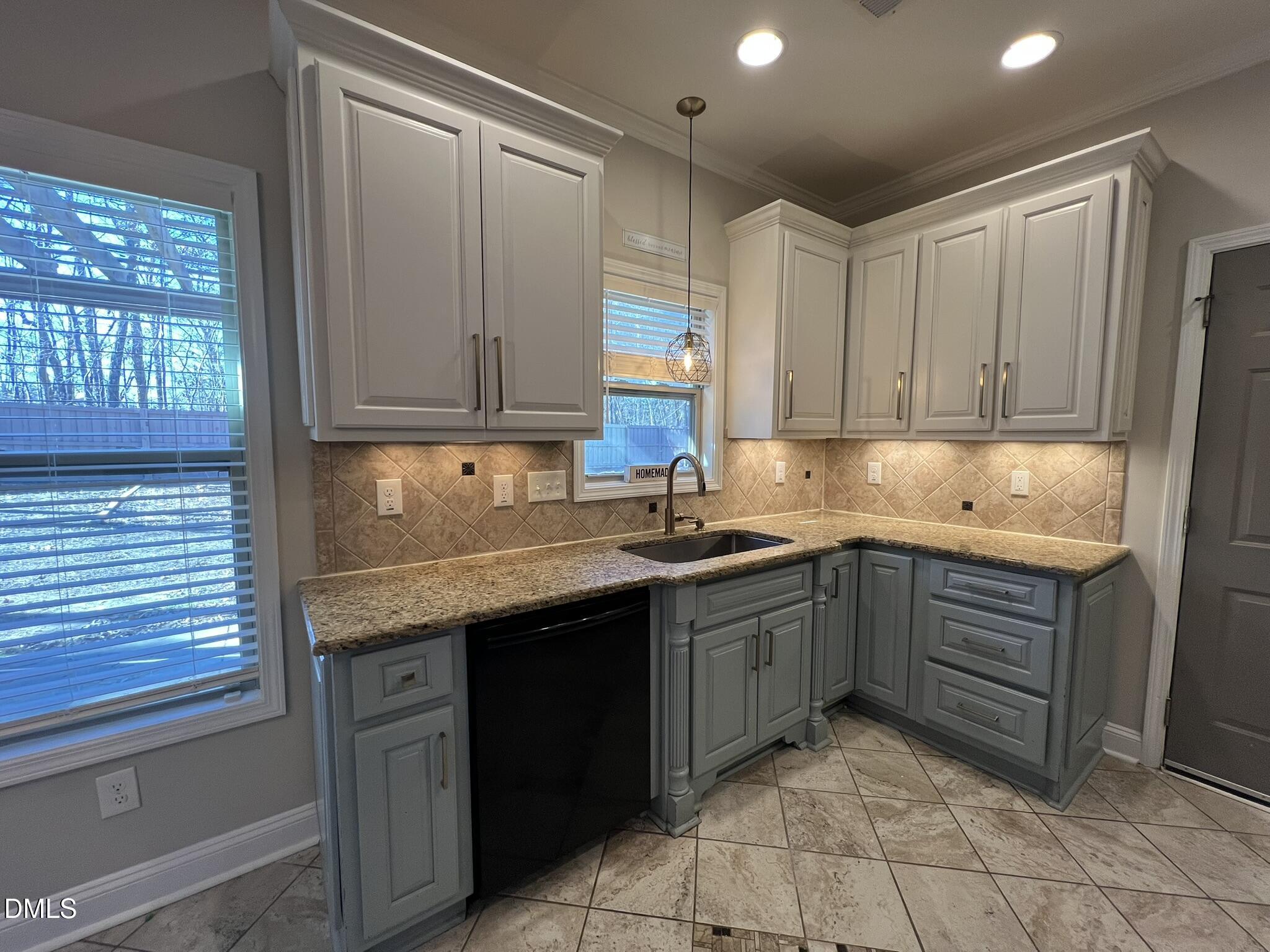 19 Eaton Drive Angier, NC 27501 - Photo 5 of 17 a kitchen with a sink window and cabinets