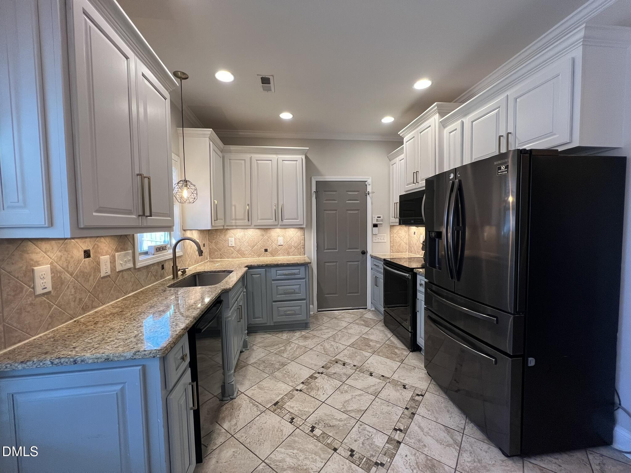 19 Eaton Drive Angier, NC 27501 - Photo 6 of 17 a kitchen with granite countertop a refrigerator and a sink
