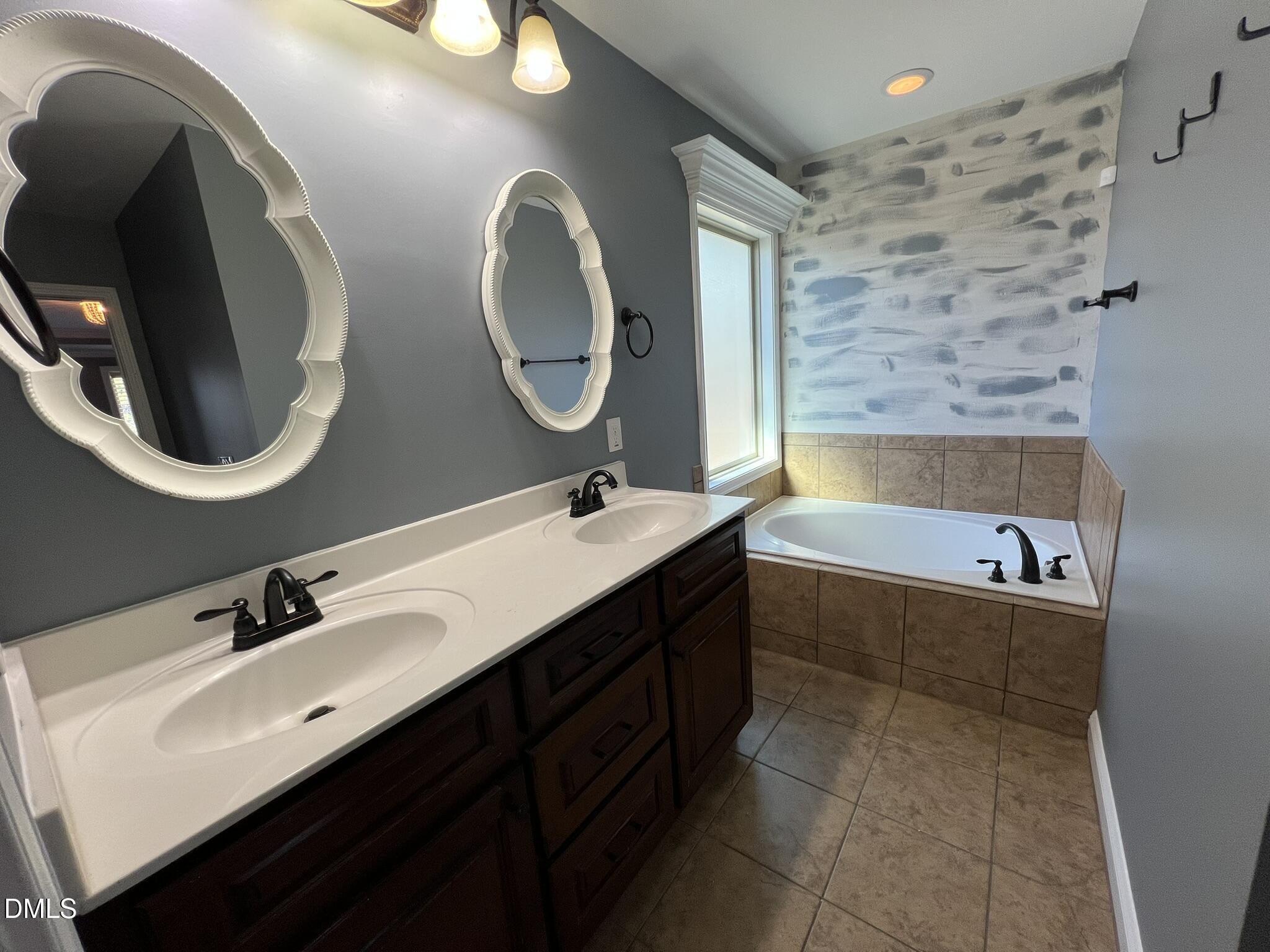 19 Eaton Drive Angier, NC 27501 - Photo 10 of 17 a bathroom with a double vanity sink and a mirror