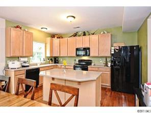 253 Lorraine Road Fort Mill, SC 29708 - Photo 3 of 16 a kitchen with a refrigerator a stove a sink dishwasher with a dining table and chairs