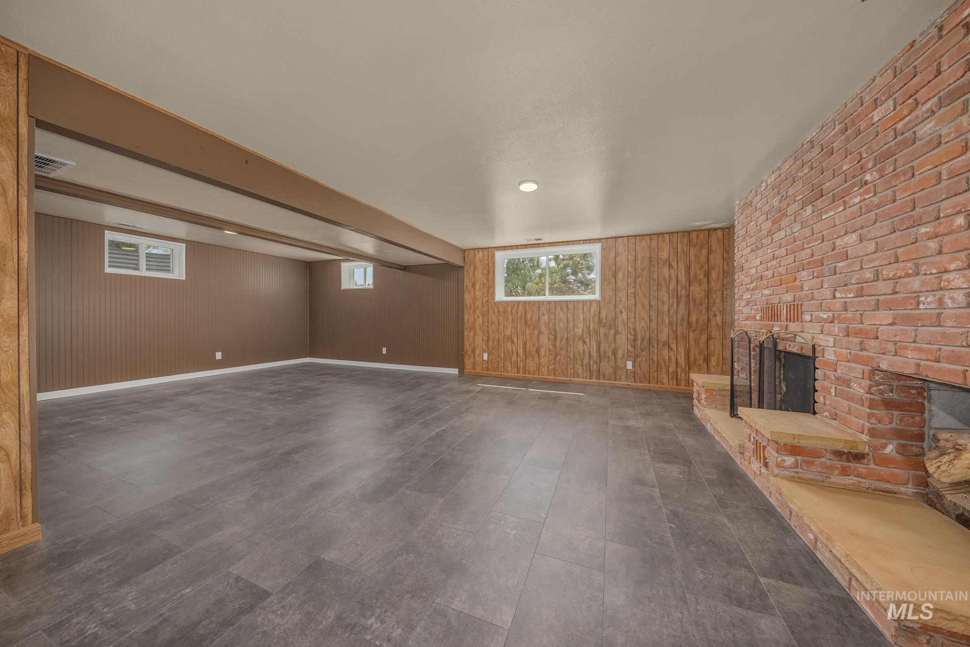 748 Pringle Road Weiser, ID 83672 - Photo 20 of 47 Spacious interior with textured brown paneling and wood-finish accent walls