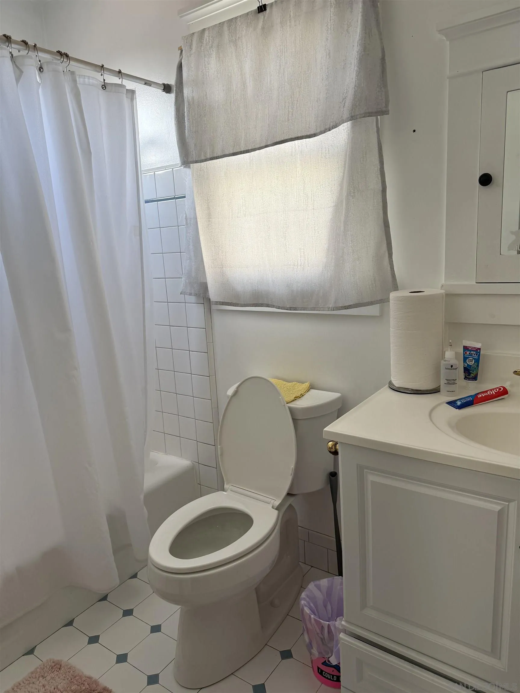 4436-38 Bancroft Street San Diego, CA 92116 - Photo 5 of 12 a bathroom with a sink toilet and shower