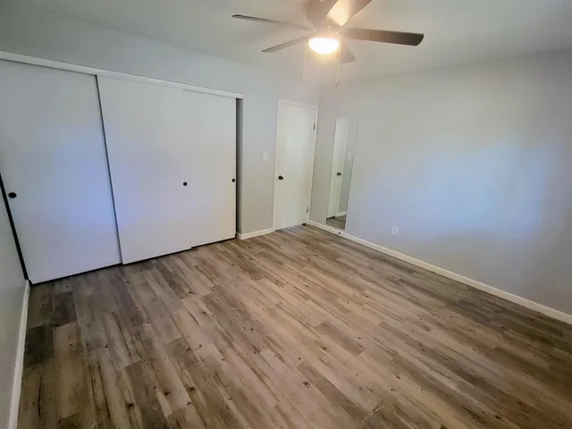 a view of an empty room with a fan