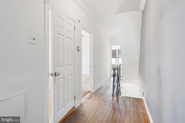 a view of hallway with wooden floor